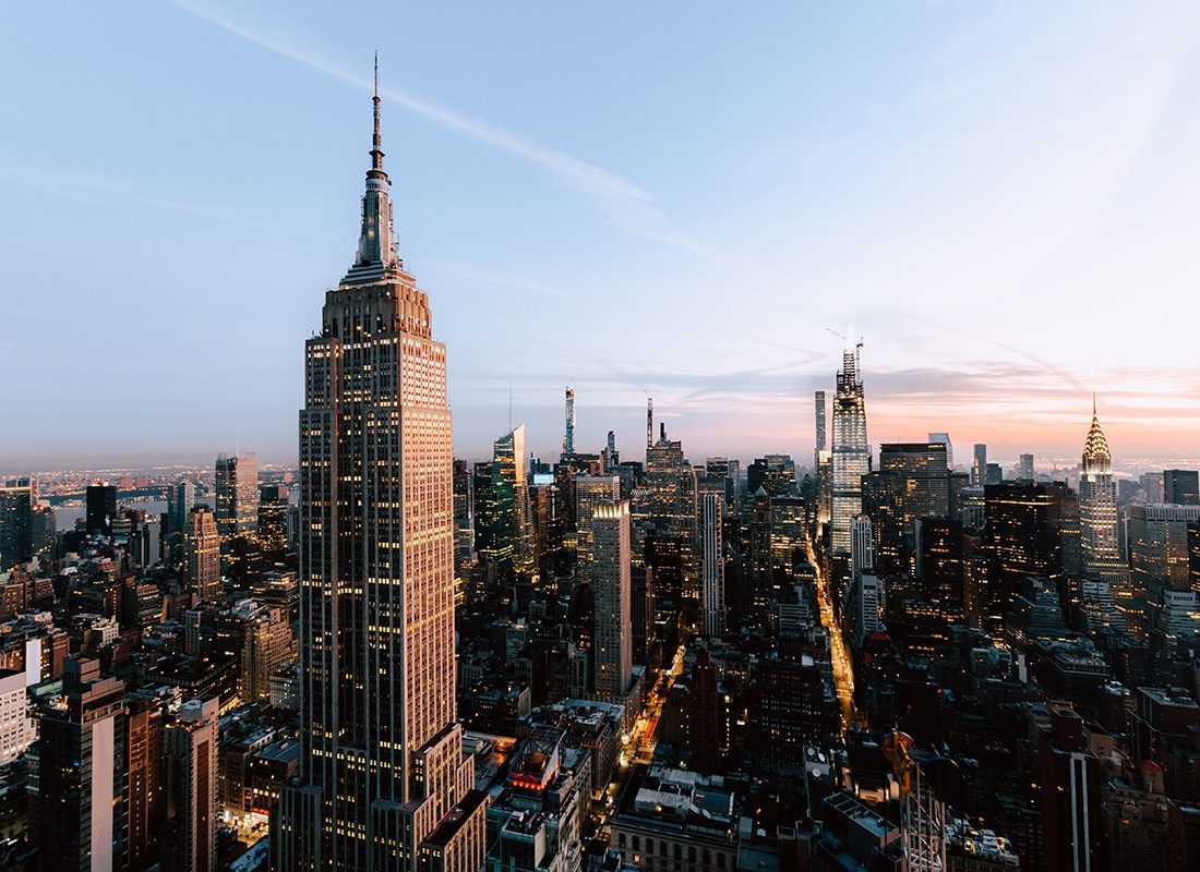 New York, NY - View of the Empire State Building and Other Commercial Buildings in Downtown New York City Against a Clear Sunsest Sky