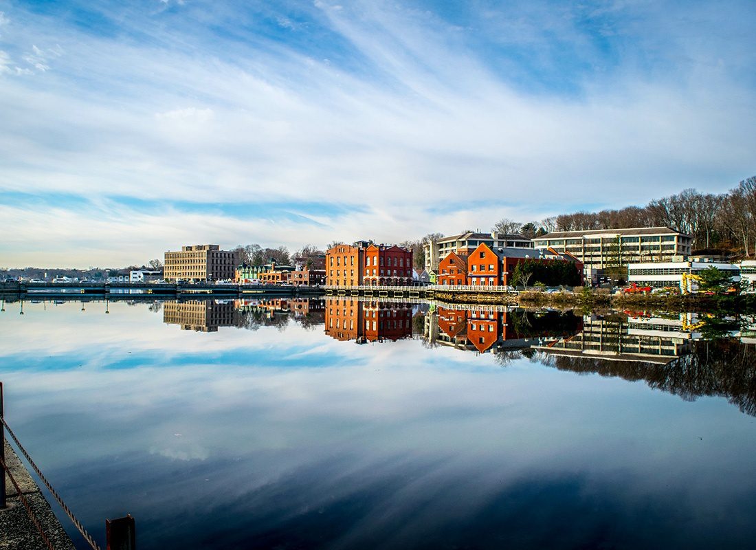 Westport, CT - View of Commercial Buildings Along the Coast with Cloud Reflections in Westport Connecticut